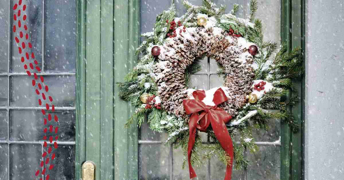 A photo of a homemade Christmas wreath on a green wooden door