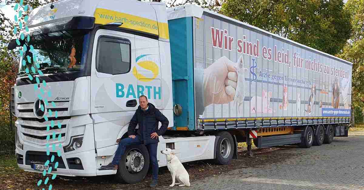 Rescued labrador mix Nelly sitting next to Markus Barth with his latest truck wrap to help laboratory animals. Contracted by Doctors Against Animal Experiments